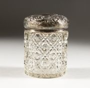 A CUT GLASS DRESSING TABLE JAR, with embossed silver top, Chester 1900. 4ins high.