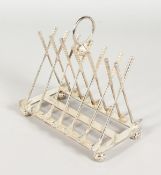 A NOVELTY PLATED GOLFING TOAST RACK.