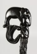 A CEYLONESE CARVED WALKING STICK with elephant handle. 35ins long.