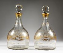 A VERY GOOD PAIR OF GEORGIAN MALLET DECANTERS AND STOPPERS, with gilt decoration, ribbons, etc.