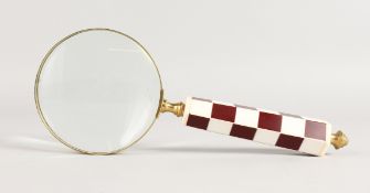 A MAGNIFYING GLASS.
