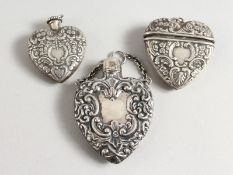 THREE HEART SHAPED SILVER PERFUME BOTTLES.