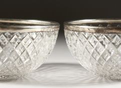 A PAIR OF SILVER BANDED CIRCULAR CUT GLASS BOWLS. 4ins diameter. Birmingham 1945.