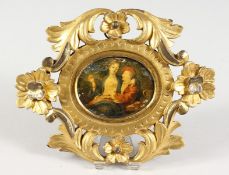 AN 18TH CENTURY ITALIAN MINIATURE IN A CARVED AND GILDED FRAME.