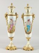 A PAIR OF TALL, SLENDER SEVRES STYLE PORCELAIN VASES with ormolu mounts. 21ins high.