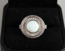 A SILVER AND GILSON OPAL RING.