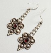 A PAIR OF SILVER AND GARNET EARRINGS.