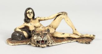 A VIENNA STYLE COLD PAINTED BRONZE OF A FEMALE NUDE ON A TIGER'S SKIN RUG. 6ins long.