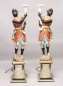 A PAIR OF PAINTED, CARVED AND BLACKAMOOR FLOOR STANDING NINE LIGHT CANDELABRA. 6ft 4ins high.
