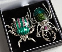 TWO SILVER RUBY AND ENAMEL BUG BROOCHES.