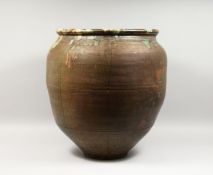 A LARGE HIGH FIRED ORIENTAL POTTERY JAR.