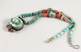 AN ISLAMIC TURQUOISE AND CORAL PENDANT.