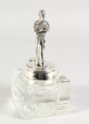A FOOTBALL INKWELL, plated man with a ball, on a square glass inkwell.