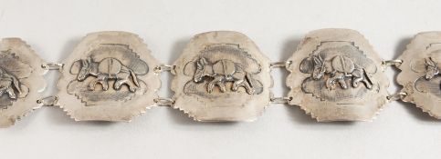 AN ISLAMIC SILVER BRACELET decorated with donkeys.