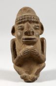 A NATIVE TERRACOTTA FIGURE OF A MAN. 6ins long.