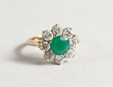 A 9CT GOLD, GREEN STONE / DIAMANTE RING.