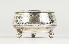 A RUSSIAN NIELLO SILVER CIRCULAR SALT, on three ball feet. 2.25ins diameter.
