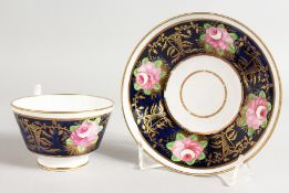 A DAVENPORT RICH BLUE CUP AND SAUCER painted with roses.