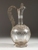 A SUPERB FILIGREE SILVER AND ETCHED GLASS CLARET JUG. 10.5ins high.