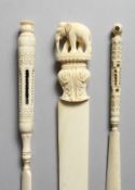 TWO CARVED IVORY STANHOPES, one of Portsmouth, 6ins long, and a paper knife carved with an elephant,