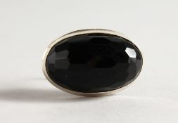 A SILVER AND JET RING.
