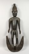 A LARGE CARVED WOOD STANDING MALE FIGURE. 42ins long.