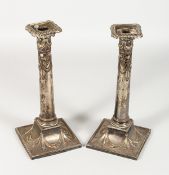 A PAIR OF ADAM DESIGN PLATE CANDLESTICKS with swags. 11ins high.