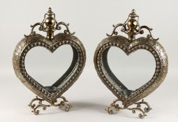 A GOOD PAIR OF GILDED METAL HEART SHAPED LANTERNS on curving feet. 22ins high.