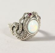 A SILVER, OPAL AND RUBY EYE SNAKE RING.