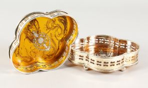A SET OF TWO SHAPED FAUX TORTOISESHELL WINE COASTERS.