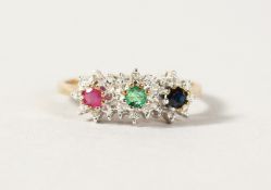 A 9CT GOLD TRIPLE FLOWER HEAD CLUSTER RING.