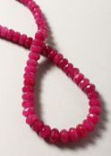 A STRING OF RUBY BEADS.