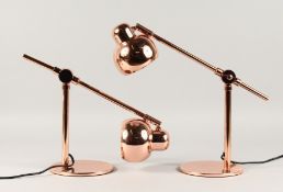 A PAIR OF COPPER ANGLE POISE LAMPS.