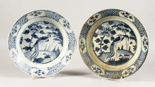 TWO CHINESE WANLI PERIOD BLUE AND WHITE PEACOCK DESIGN PLATES. 11ins diameter.