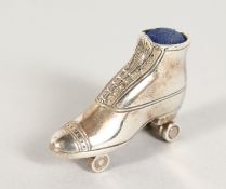 A CAST SILVER ROLLER SKATE PIN CUSHION.