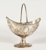 A VICTORIAN BOAT SHAPED SUGAR BASKET with repousse decoration, bead handle and edge. London 1868.