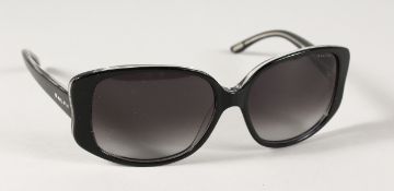 A PAIR OF RALPH LAUREN SUN GLASSES in a case.