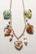 A SILVER NECKLACE with glass hearts.