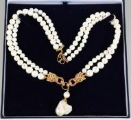 A SILVER AND GOLD PLATED, RUBY AND PEARL DOUBLE-ROW NECKLACE.