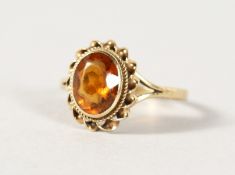 A 9CT GOLD TOPAZ RING.
