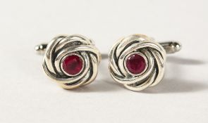 A PAIR OF SILVER AND RUBY KNOT CUFFLINKS.