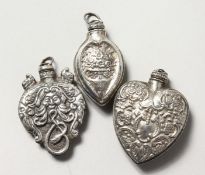 THREE SILVER PERFUME BOTTLES.