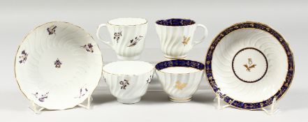 TWO BARR WORCESTER TRIOS, one painted with puce flower, the other with a blue and gilt border,