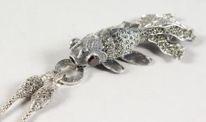 AN ARTICULATED FISH on a silver and marcasite chain.