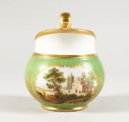A RUSSIAN GREEN GROUND JUG with a village scene. 5ins high.