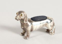 A CAST SILVER DACHSHUND PIN CUSHION.