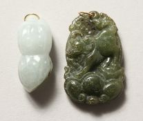 TWO CARVED JADE GOLD TOP PENDANTS.