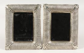 A PAIR OF METAL UPRIGHT PHOTOGRAPH FRAMES with pierced borders. 8ins x 6ins.