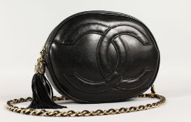 A GOOD CHANEL PADDED BLACK LEATHER BAG with entwined CC, 9.5ins wide, with long leather and gilt