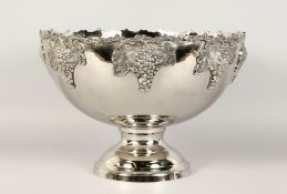 A LARGE SILVER PLATE CIRCULAR PUNCH BOWL with fruiting vines, on a circular base. 15ins diameter.